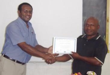 Senior Pastor John receiving his certificate from Bryan.